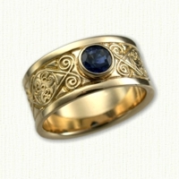 14kt yellow gold Celtic Triskele Knot Wedding Band set with a bezel set round blue sapphire