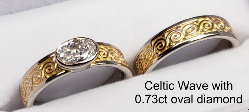 14kt white gold Celtic Wave Knot Band with 18kt yellow gold electroplating and 0.73ct oval diamond